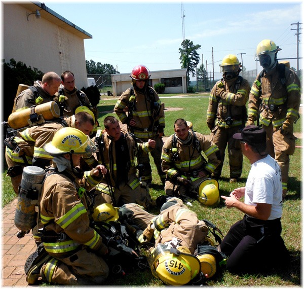 Firefighter Team Circled Around Instructor, Instructor kneeling